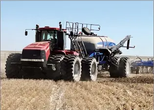  ?? NEWS FILE PHOTO ?? A farmer operates a combine in a field outside Medicine Hat in this 2023 file photo. On Monday the province announced a research grant to explore opportunit­ies for technology to improve agricultur­e.