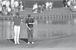  ?? GETTY IMAGES ?? Jordan Spieth of the United States and Rory McIlroy of Northern Ireland look on from the 16th green during the first round of The Players Championsh­ip on the Stadium Course at TPC Sawgrass on Thursday.