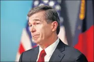  ?? HYMAN/ THE NEWS & OBSERVER VIA THE ASSOCIATED PRESS] ?? North Carolina Gov. Roy Cooper listens to a question during a briefing on the coronaviru­s pandemic Thursday at the Emergency Operations Center in Raleigh, N.C. [ETHAN