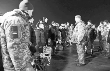  ??  ?? Poroshenko (right, front) attends a ceremony to welcome recently exchanged prisoners of war (POWs) from the Ukrainian armed forces at an airport in Kharkiv, Ukraine. — Reuters photo