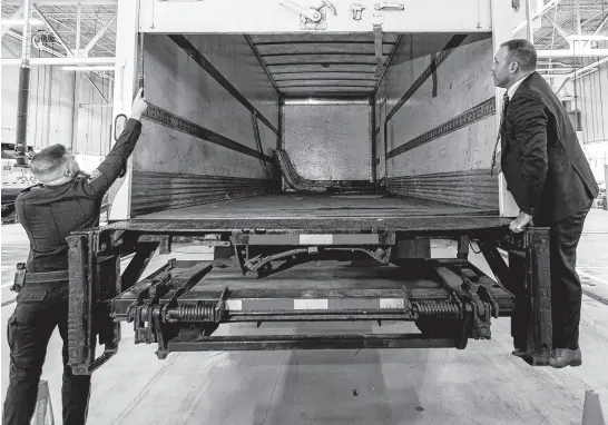  ?? REUTERS ?? Police officers open the back of the truck used in the heist after authoritie­s gave details of the arrests made one year after some 400 kg (882 pounds) of gold and almost $2 million USD in cash was stolen from Toronto Pearson Internatio­nal Airport, at a news conference in Brampton, Ont., April 17.