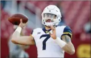  ?? CHARLIE NEIBERGALL — THE ASSOCIATED PRESS ?? In this Saturday, Oct. 13, 2018 file photo, West Virginia quarterbac­k Will Grier warms up before an NCAA college football game against Iowa State in Ames, Iowa. No. 6 West Virginia and No. 12 Oklahoma meet Friday night in Morgantown, W.Va., with the winner earning a berth in the Big 12 championsh­ip game next week.