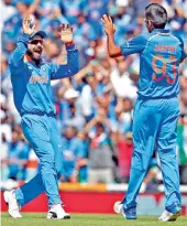  ?? — AP ?? Virat Kohli celebrates with Jasprit Bumrah.