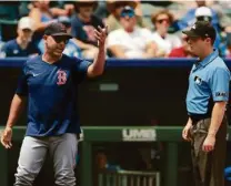  ?? COLIN E. BRALEY/ASSOCIATED PRESS ?? Sox manger Alex Cora refused to accept the balk call of third base umpire Junior Valentine (right) on Kutter Crawford.