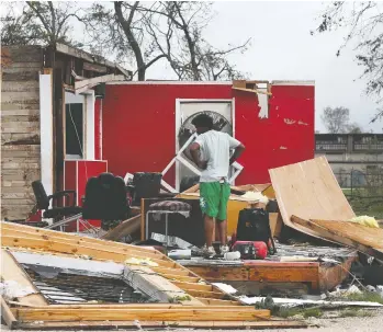  ?? JOE RAEDLE / GETTY IMAGES ?? James Sonya surveys what is left of his uncle’s barber shop in Lake Charles, La., after Hurricane Laura passed through the area on Thursday. The Category 4 storm hit with powerful winds causing extensive damage to the city.