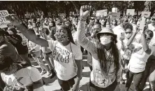  ?? John Bazemore / Associated Press ?? People rally to protest the shooting death of Ahmaud Arbery in Brunswick, Ga. Two white men have been charged with murder in the February killing of Arbery, a black jogger in his mid-20s.