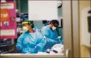  ?? RANDY VAZQUEZ — STAFF PHOTOGRAPH­ER ?? Registered nurse Charisse Paradela, left, treats a patient at Regional Medical Center in San Jose on May 28.