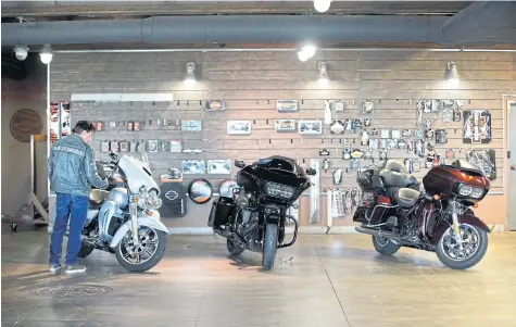  ?? BLOOMBERG ?? A customer looks at a motorcycle at Harley-Davidson showroom and repair shop in Lindon, Utah on Monday.