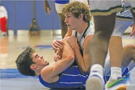  ?? STAFF PHOTO BY OLIVIA ROSS ?? Notre Dame’s Cole McCormick, top, and McCallie’s Parker Robison fight for the basketball during a semifinal matchup in the Times Free Press Best of Preps tournament Friday night at Chattanoog­a State. The three-day event wraps up Saturday with eight more games.