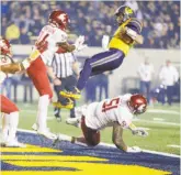  ??  ?? Cal quarterbac­k Ross Bowers somersault­s over the Washington State defense and nearly lands on his feet on a 7-yard touchdown run that put the Bears ahead 27-3 in the fourth quarter.