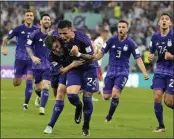  ?? NATACHA PISARENKO — THE ASSOCIATED PRESS ?? Argentina's Julian Alvarez, front left, is embraced by teammate Enzo Fernandez after scoring a goal during a Group C match at the World Cup on Wednesday.