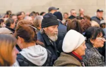  ?? ?? Internally displaced Ukrainians from the country’s east line up to receive food donations at the Church of Saint Joseph in Dnipro, amid the Russia invasion on Tuesday.