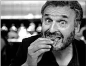  ?? MYUNG J. CHUN/LOS ANGELES TIMES ?? Phil Rosenthal of Netflix’s “Somebody Feed Phil” savors a crispy, layered bread called malawach at Bavel in LA.