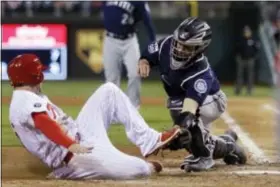  ?? MATT SLOCUM — THE ASSOCIATED PRESS ?? Seattle catcher Tuffy Gosewisch, right, tags out the Phillies’ Daniel Nava at home as Nava tried to score on a fly-out by Maikel Franco during the eighth inning Tuesday.