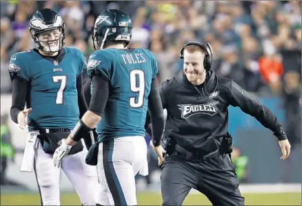  ?? Patrick Semansky Associated Press ?? NICK FOLES, being congratula­ted by quarterbac­ks Carson Wentz, right, and Nate Sudfeld, could be the hero of the Super Bowl. Foles has led the Philadelph­ia Eagles after replacing Wentz, who suffered a season-ending knee injury in Week 14 against the Rams.