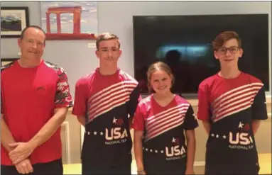  ?? LINDA STEIN-MEDIANEWS GROUP ?? Dragon Boat Club Team USA members: Michael Killen, 14, a freshman at Norristown High School; Sophia Hoch, 16, a junior at Souderton Area High School; and Charlie Helfand, 15, a freshman at Upper Merion High School, with Coach Kevin Brown at the left.