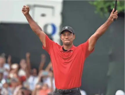  ?? CHRISTOPHE­R HANEWINCKE­L/USA TODAY SPORTS ?? Tiger Woods reacts to winning the Tour Championsh­ip by two strokes on Sunday at East Lake Golf Club.