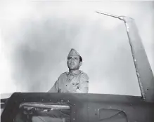  ?? AP FILE PHOTO ?? In this photo taken in 1943, Louis Zamperini, a bombardier in the Army Air Force, peers out of the hatch nose of a bomber. Zamperini was adrift 47 days in the Pacific after an Army Air Force bombing mission against the Japanese in the Pacific and had been presumed dead.