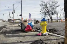  ?? BONNIE MEIBERS / STAFF ?? A memorial was placed at the scene of a Christmas Day crash at Brooklyn Avenue and West Third Street that left four relatives dead and four more in critical conditions.