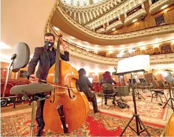  ?? — AFP photo ?? Musicians of the Sofia Opera’s orchestra tune and prepare their instrument­s prior to the opera La Traviata by Italian composer Giuseppe Verdi, at the Sofia Opera, in Sofia.