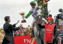  ?? PHOTO: GETTY IMAGES ?? Melbourne Cup winning jockey Michelle Payne delivers the 2016 trophy before the big race at Flemington last November.