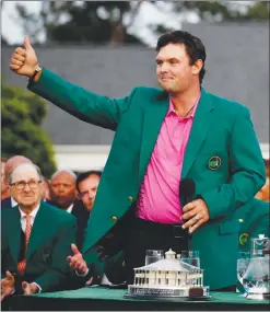  ?? Associated Press photo ?? Patrick Reed gives a thumbs up after being presented with the championsh­ip trophy after winning the Masters golf tournament Sunday in Augusta, Ga.