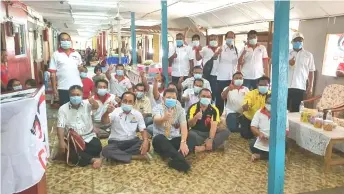  ??  ?? Huang (seated front, third left) gestures during a community developmen­t programme at the longhouse of Tuai Rumah Setia Unggok (second left).