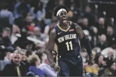  ?? ASSOCIATED PRESS ?? IN THIS FEB. 8 FILE PHOTO, New Orleans Pelicans guard Jrue Holiday celebrates a 3-point basket late in a game against the Indiana Pacers in Indianapol­is.