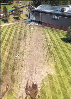  ?? Mark Mirko / Associated Press ?? Wreckage from a Cessna Citation 560X aircraft is visible after after it crashed into a building at the manufactur­ing company Trumpf Inc. in Farmington and caught fire Thursday, after taking off from nearby Robertson Airport in Plainville. The small jet crashed shortly after taking off, killing all four people aboard, officials said.