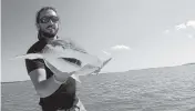  ?? COLBY GRIFFITHS AP file, 2015 ?? Scientist Bryan Keller, with a bonnethead shark in the North Edisto River in South Carolina, is among a group of scientists that found sharks use the Earth’s magnetic field as a sort of natural GPS when they navigate journeys that take them thousands of miles across the world’s oceans.