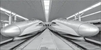  ?? LI AN / XINHUA ?? Two high-speed bullet trains sit in Zhengzhou Railway Station in Henan province on Tuesday.