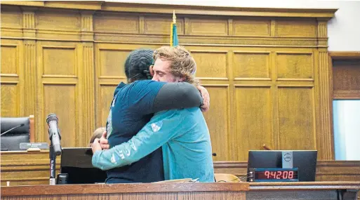  ?? MARY TAYLOR ?? Christina McCullough embraces Julian Treat as he graduates, despite some setbacks, from Seattle’s drug-court program. Treat now has steady employment.