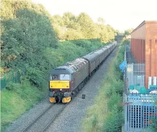  ??  ?? ●●A rare passenger train passing through closed down Cheadle Heath station