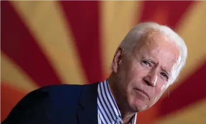  ??  ?? Joe Biden pauses while speaking to supporters in front of an Arizona state flag, in Phoenix this month. Photograph: Brendan Smialowski/ AFP/Getty Images