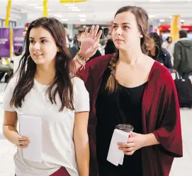  ?? MARK BLINCH/THE CANADIAN PRESS ?? Eden Kazoleas, left, and Jessica Drolet, return to Canada at Toronto Pearson Internatio­nal Airport on Friday after they were detained in Cambodia.