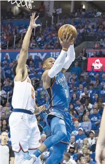  ??  ?? RUSSELL WESTBROOK of the Oklahoma City Thunder slides past Courtney Lee of the New York Knicks for two points during the first half of a NBA game at the Chesapeake Energy Arena on Oct. 19 in Oklahoma City, Oklahoma.