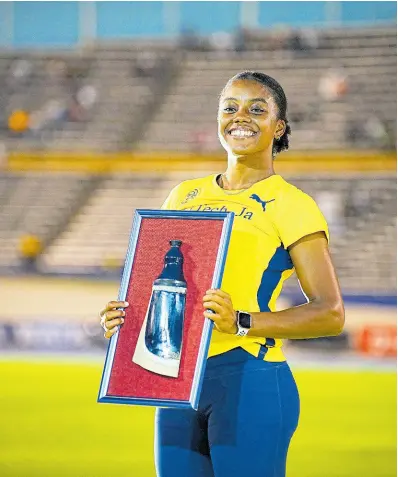  ?? GLADSTONE TAYLOR/MULTIMEDIA PHOTO EDITOR ?? Krystal Sloley of Jamaica beams with pride as she displays her award for placing second in the women’s 100 metres at the Jamaica Athletics Invitation­al held at the National Stadium on Saturday, May 11, 2024. The event was won by Marie-Josee Ta Lou-Smith of Côte d’Ivoire.