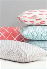  ?? Crane & Canopy/AP ?? Fresh color: At left, this undated photo provided by Crane & Canopy shows a selection of their throw pillows featuring fresh, energetic hues and a bold pattern. At right, this photo provided by Amy Sklar Design shows a nook under some home stairs that...