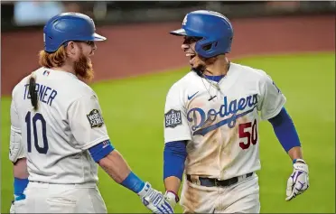  ?? ERIC GAY/AP PHOTO ?? The Dodgers’ Mookie Betts, right, celebrates his sixth-inning home run with Justin Turner during Game 1 of the World Series on Tuesday night in Arlington, Texas. Los Angeles beat the Tampa Bay Rays 8-3.