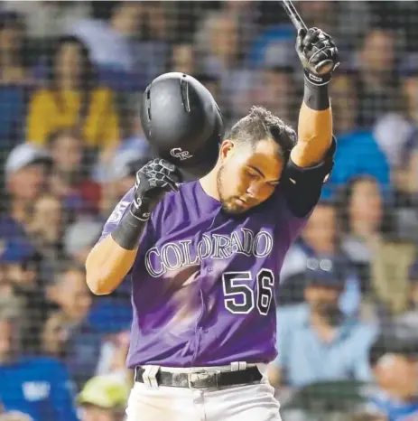  ?? Charles Rex Arbogast, The Associated Press ?? Rockies rookie right fielder Noel Cuevas regroups while batting against Chicago Cubs reliever Pedro Strop during the eighth inning on Monday night. Cuevas went 3-for-4 but did not score.