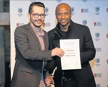  ?? Picture: SUPPLIED ?? NO JOKE: Mdantsane comedian Tats Nkonzo received his first National Arts Festival Silver Ovation Award by the festival’s executive producer Ashraf Johaardien