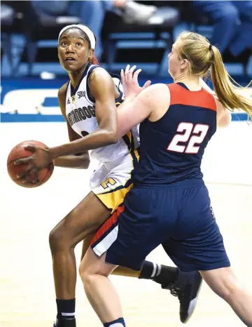  ?? STAFF FILE PHOTO BY ROBIN RUDD/ ?? UTC’s Jasmine Joyner looks toward the basket while being guarded by Samford’s Ellen Riggins during a game at McKenzie Arena in February.