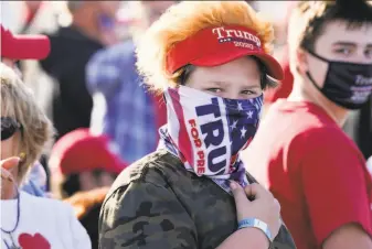  ?? Charlie Neibergall / Associated Press ?? A supporter waits for President Trump to speak during a campaign rally at Des Moines Internatio­nal Airport. Trump won Iowa handily in 2016 but Joe Biden is making a late push there.