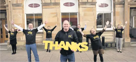  ??  ?? Best foot forward Bernard Smith of Whiteleys Retreat checks in with the McKinstry team to thank them for their fantastic fundraisin­g efforts