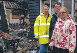  ?? FM3538358 ?? Lorraine Mason, Craig Holes and Hannah Mason look at the damage