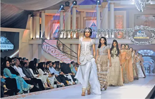  ??  ?? Models present creations by Pakistani designer Shabnam Naz during Bridal Couture Week in Karachi, on Saturday.