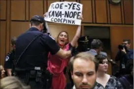  ?? AP PHOTO/JACQUELYN MARTIN ?? A woman voices her opposition to Supreme Court nominee Brett Kavanaugh during a Senate Judiciary Committee confirmati­on hearing on Capitol Hill Tuesday.