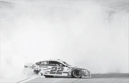  ?? SEAN GARDNER GETTY IMAGES ?? Joey Logano celebrates with a burnout after winning the Monster Energy NASCAR Cup Series Ford EcoBoost 400 and the Cup series championsh­ip.