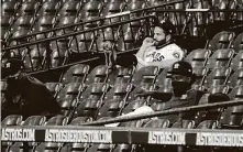  ?? Karen Warren / Staff photograph­er ?? Astros star Jose Altuve, who was given Wednesday night off in an effort to shake off thinking about his hitting slump, sits in the stands during the second inning at Minute Maid Park.