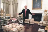  ?? CHRIS KLEPONIS/POOL/GETTY IMAGES ?? U.S President Donald Trump presents fast food to be served to the Clemson Tigers football team to celebrate their Championsh­ip at the White House on Monday in Washington, D.C. President Trump tweeted that he bought “over 1000 hamberders”; but the White House said he bought 300.